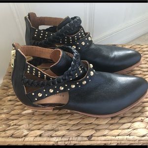 Black leather ankle boots with golden rivets